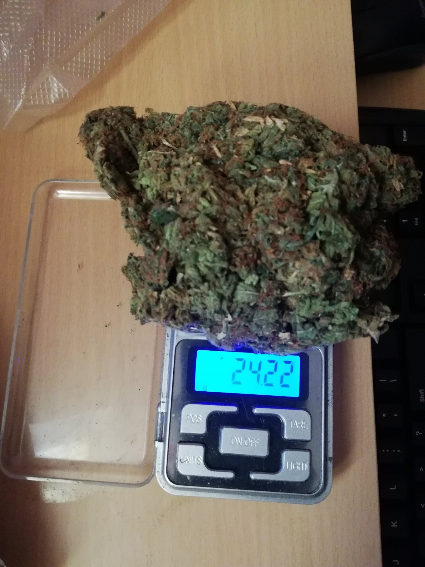 Dried cannabis flower weighed for an online order